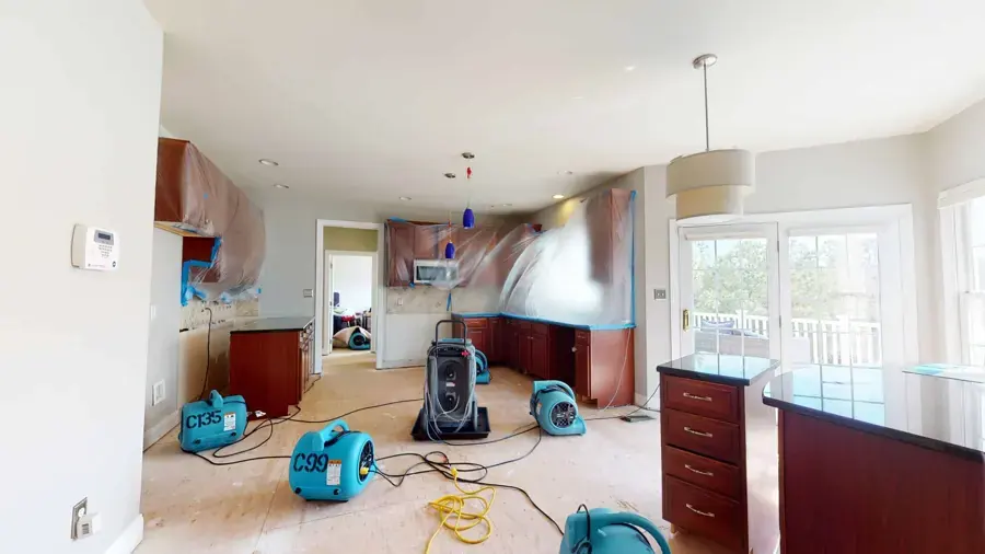 Air movers and a dehumidifier drying an open kitchen and living area in a Lancaster, SC home